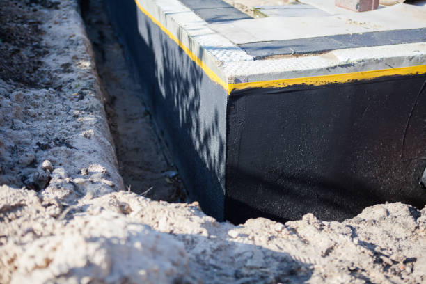 Professional Emergency Waterproofing technician working in Urbana, IN